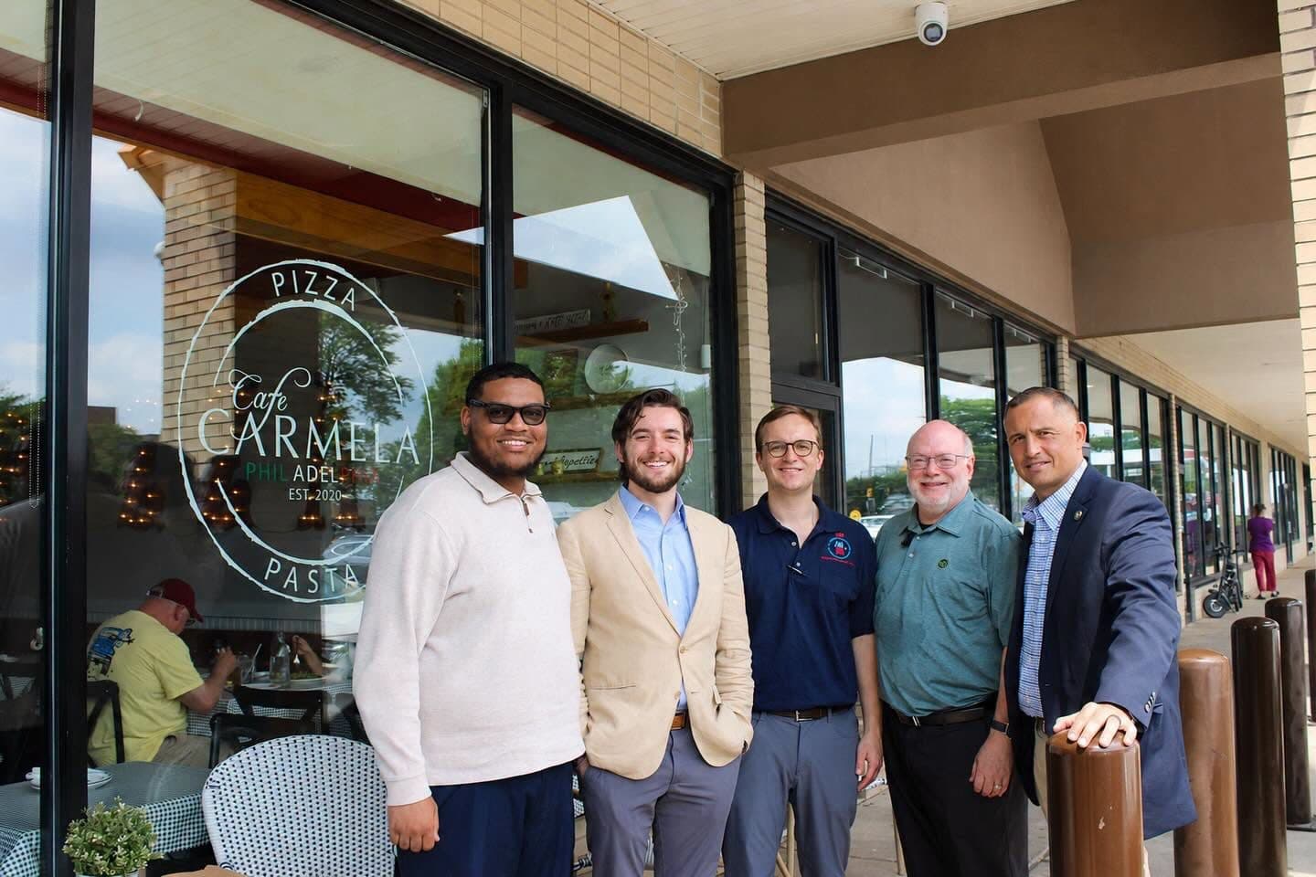 Joe Picozzi standing with small business owners outside a pizza shop in Northeast Philadelphia