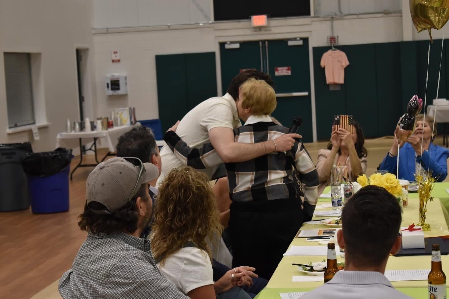 Joe Picozzi greeting neighbors at a community dinner