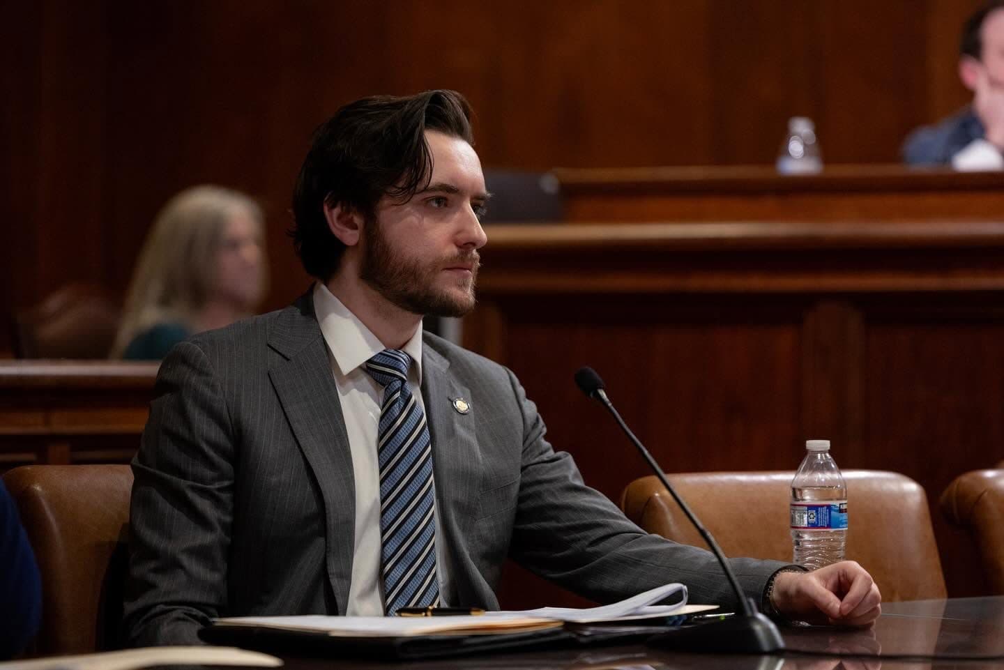 Joe Picozzi seated at a microphone during a Senate hearing