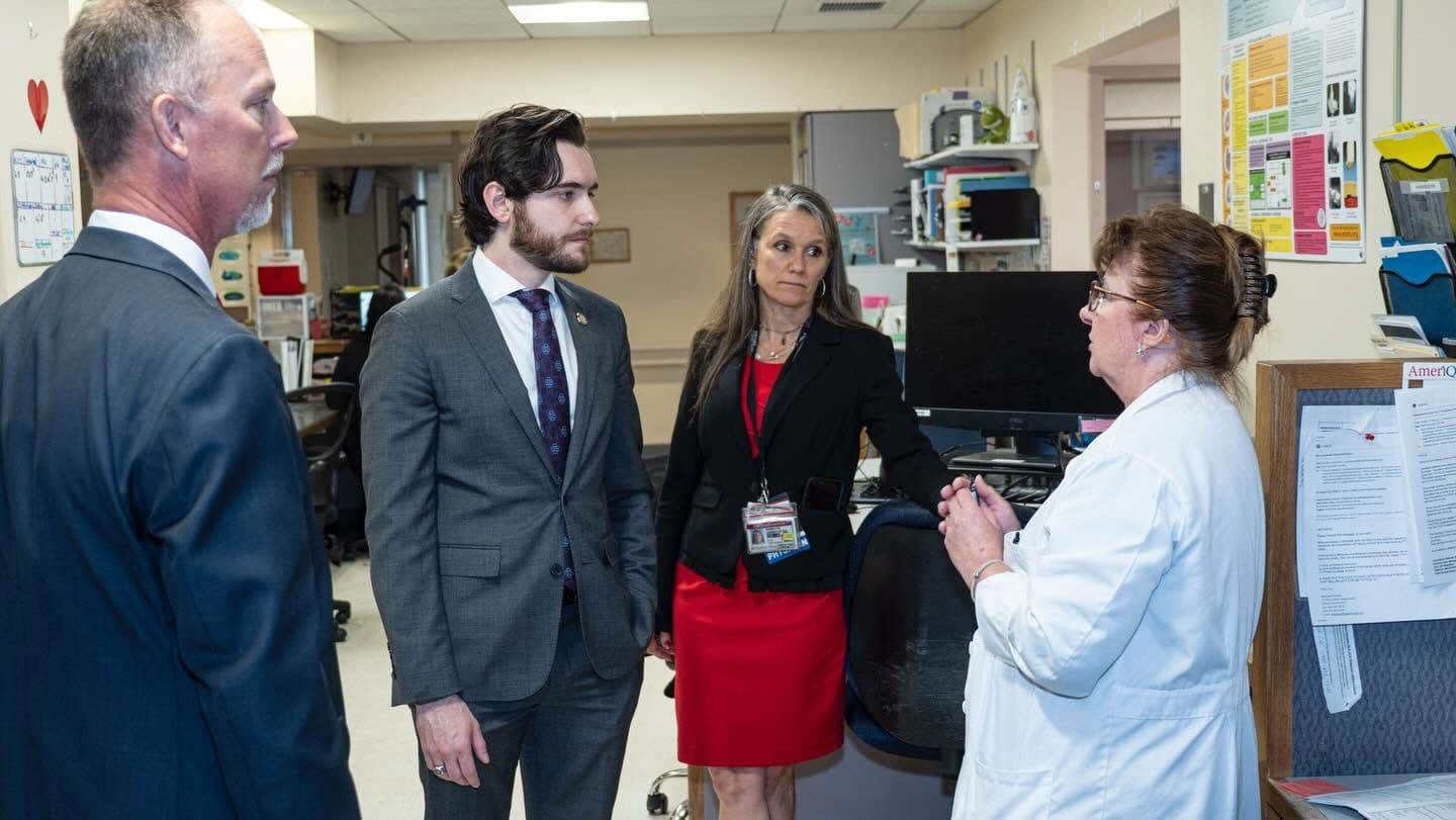 Joe Picozzi talking with hospital staff during a visit
