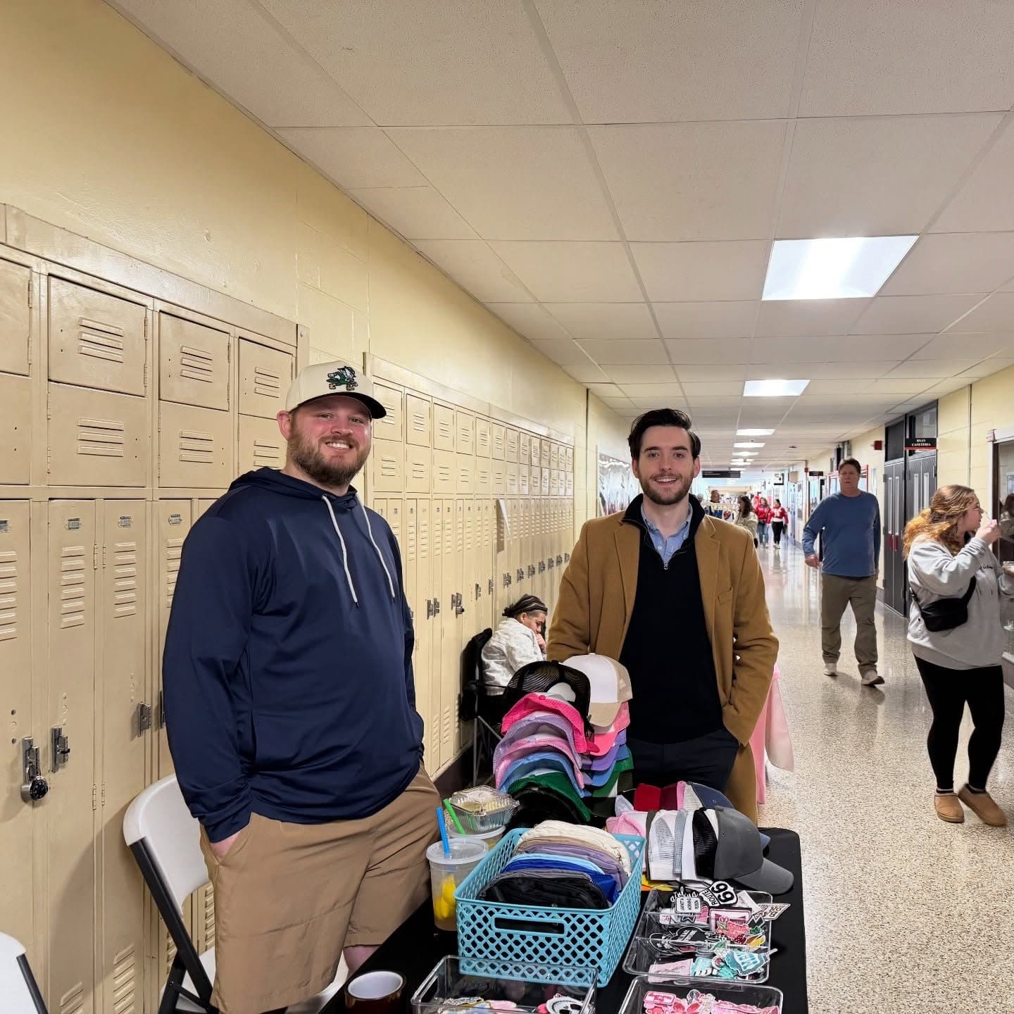 Joe Picozzi at a vendor table in a school hallway during the Archbishop Ryan craft fair